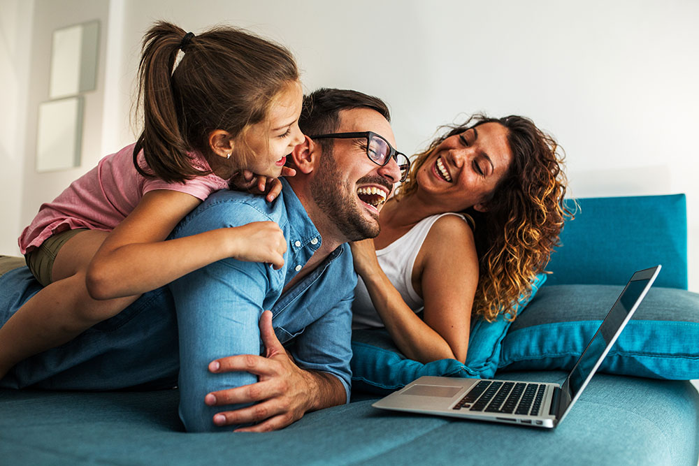 happy family looking at a computer